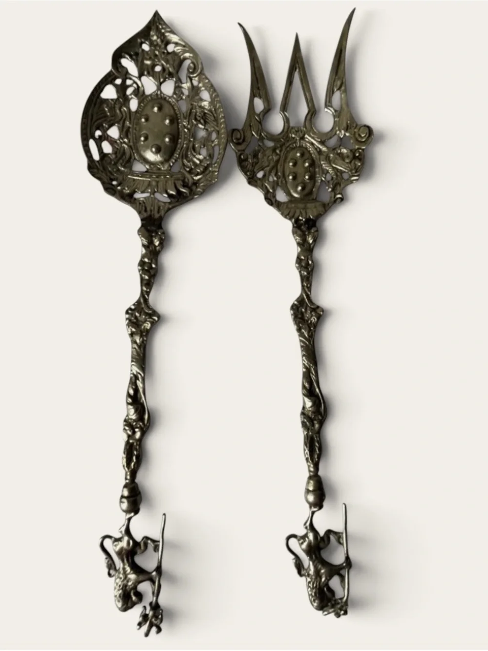 vintage Italian serving utensils are an ornate brass fork and spoon set